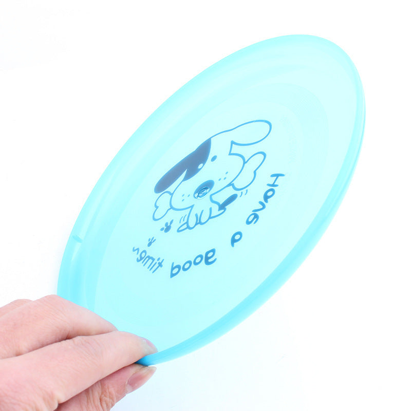 Light blue disc with a dog illustration and text held by a hand on a white background